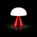 Lexon MINA piros hordozható LED asztali lámpa, bekapcsolt fehér fénnyel sötét háttér előtt